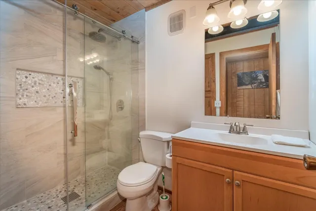 a bathroom with a sink toilet and shower