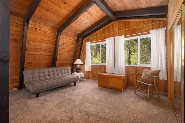 a bedroom with furniture and a large window