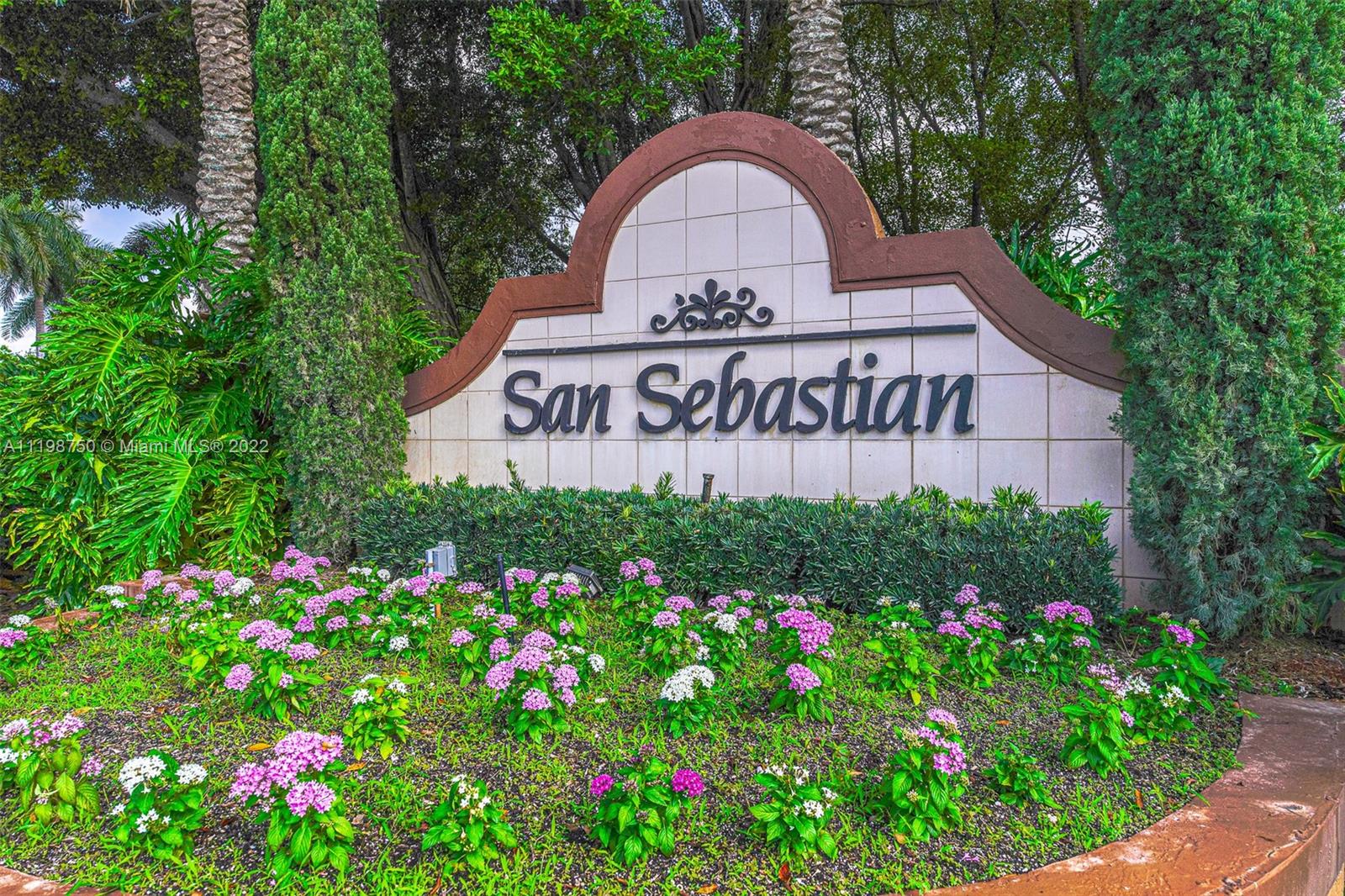 a view of sign board with flower around