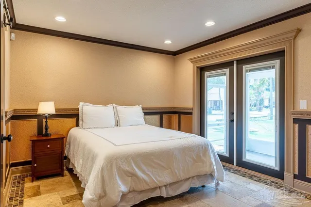 a bedroom with a bed and a refrigerator