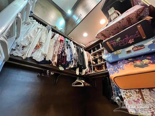 a bed room with a bed a television and a window