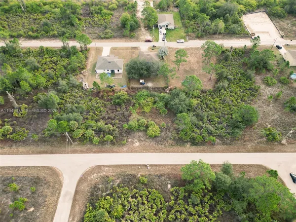 an aerial view of a house with yard and lake view