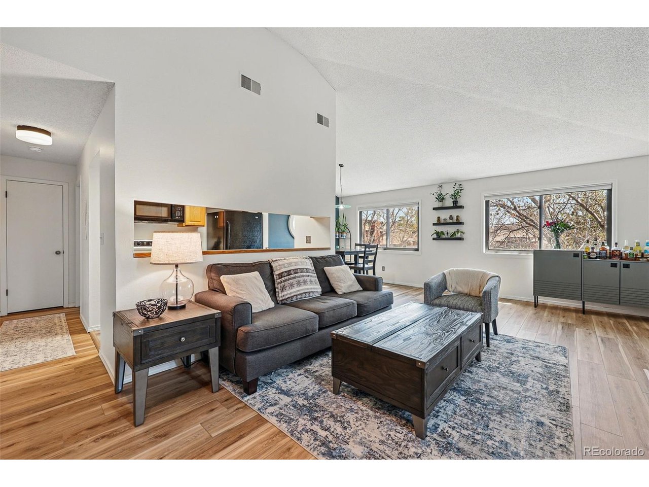 a living room with furniture and wooden floor