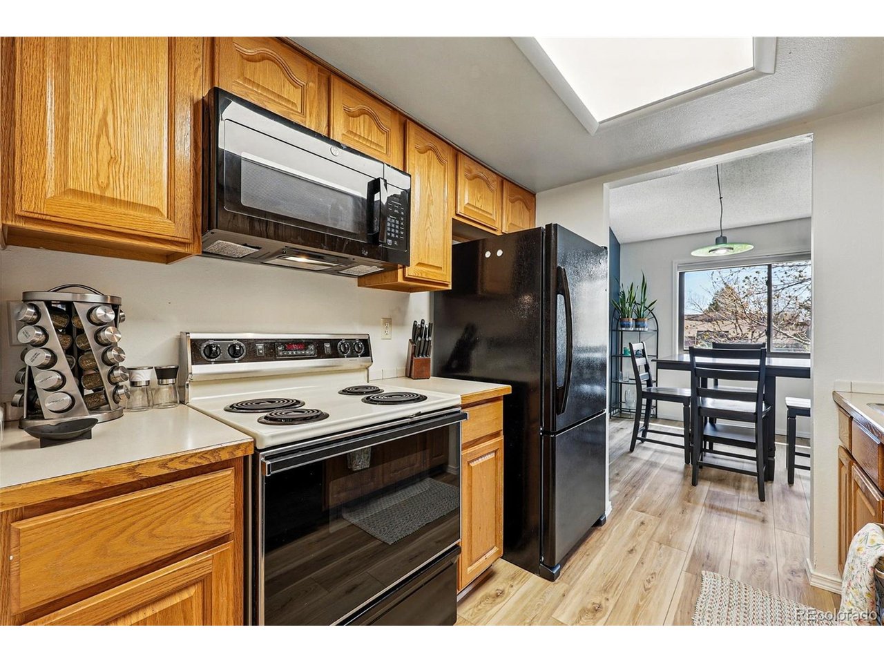 540 South Forest Street, Unit 204 Denver, CO 80246 - Photo 14 of 46 a kitchen with stainless steel appliances a stove a sink and a microwave