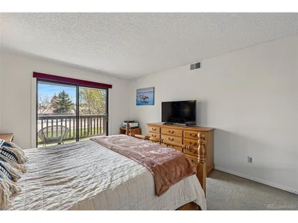 a bedroom with a bed and a television