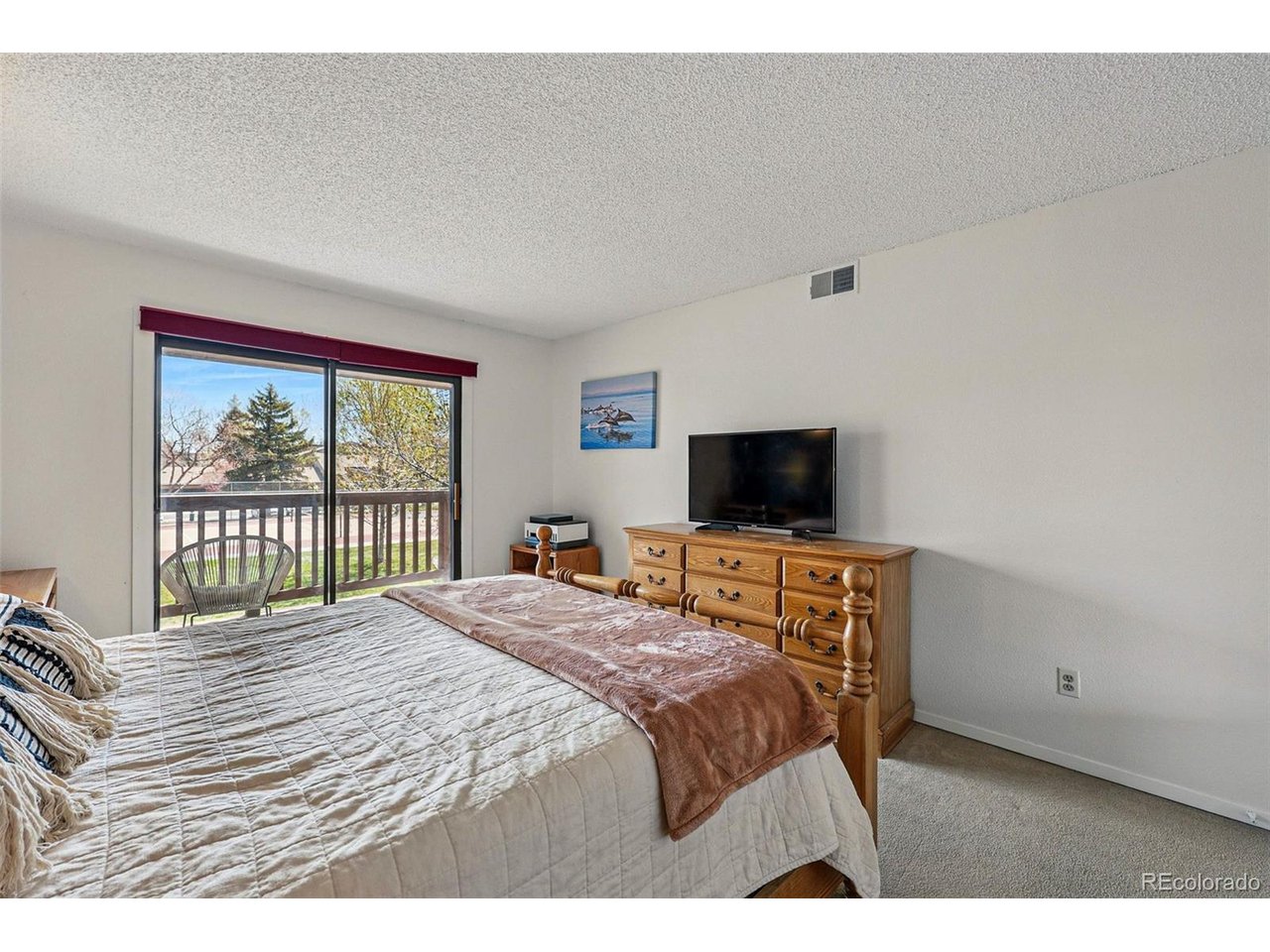 540 South Forest Street, Unit 204 Denver, CO 80246 - Photo 19 of 46 a bedroom with a bed and a television