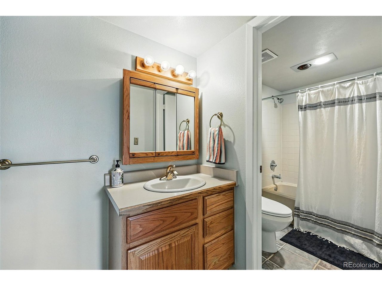 540 South Forest Street, Unit 204 Denver, CO 80246 - Photo 25 of 46 a bathroom with a sink a toilet and a mirror