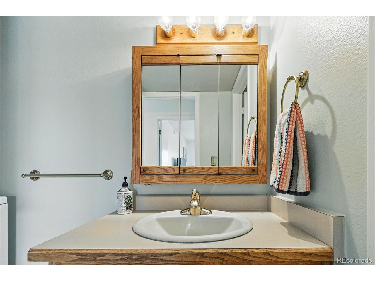 540 South Forest Street, Unit 204 Denver, CO 80246 - Photo 26 of 46 a bathroom with a sink and a mirror