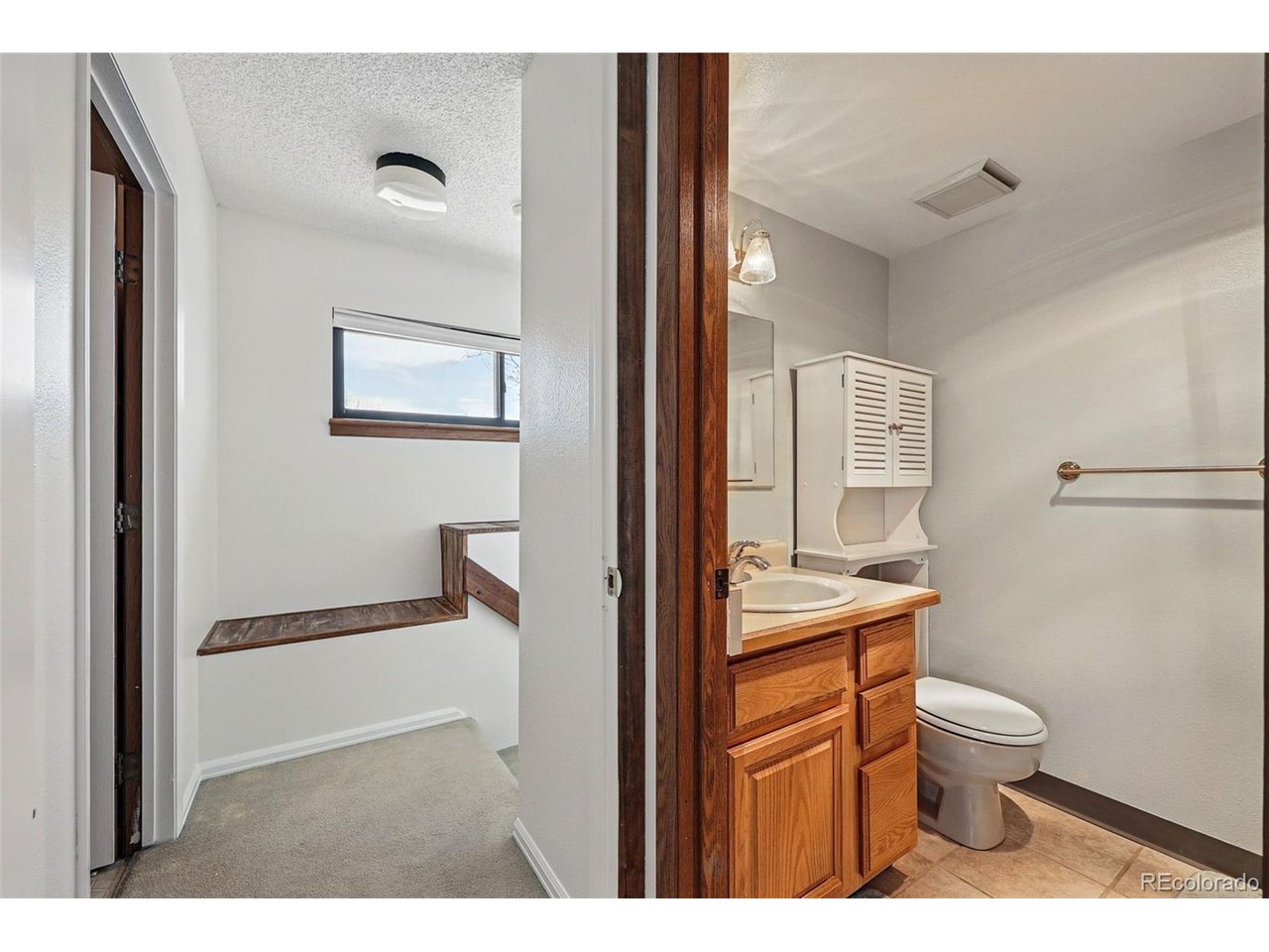 540 South Forest Street, Unit 204 Denver, CO 80246 - Photo 30 of 46 a bathroom with a toilet a sink and mirror