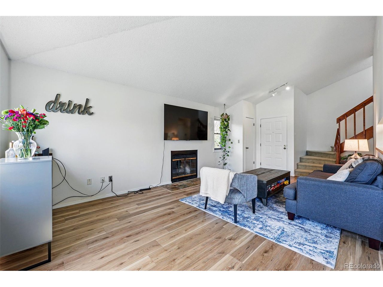 540 South Forest Street, Unit 204 Denver, CO 80246 - Photo 6 of 46 a living room with furniture and a flat screen tv