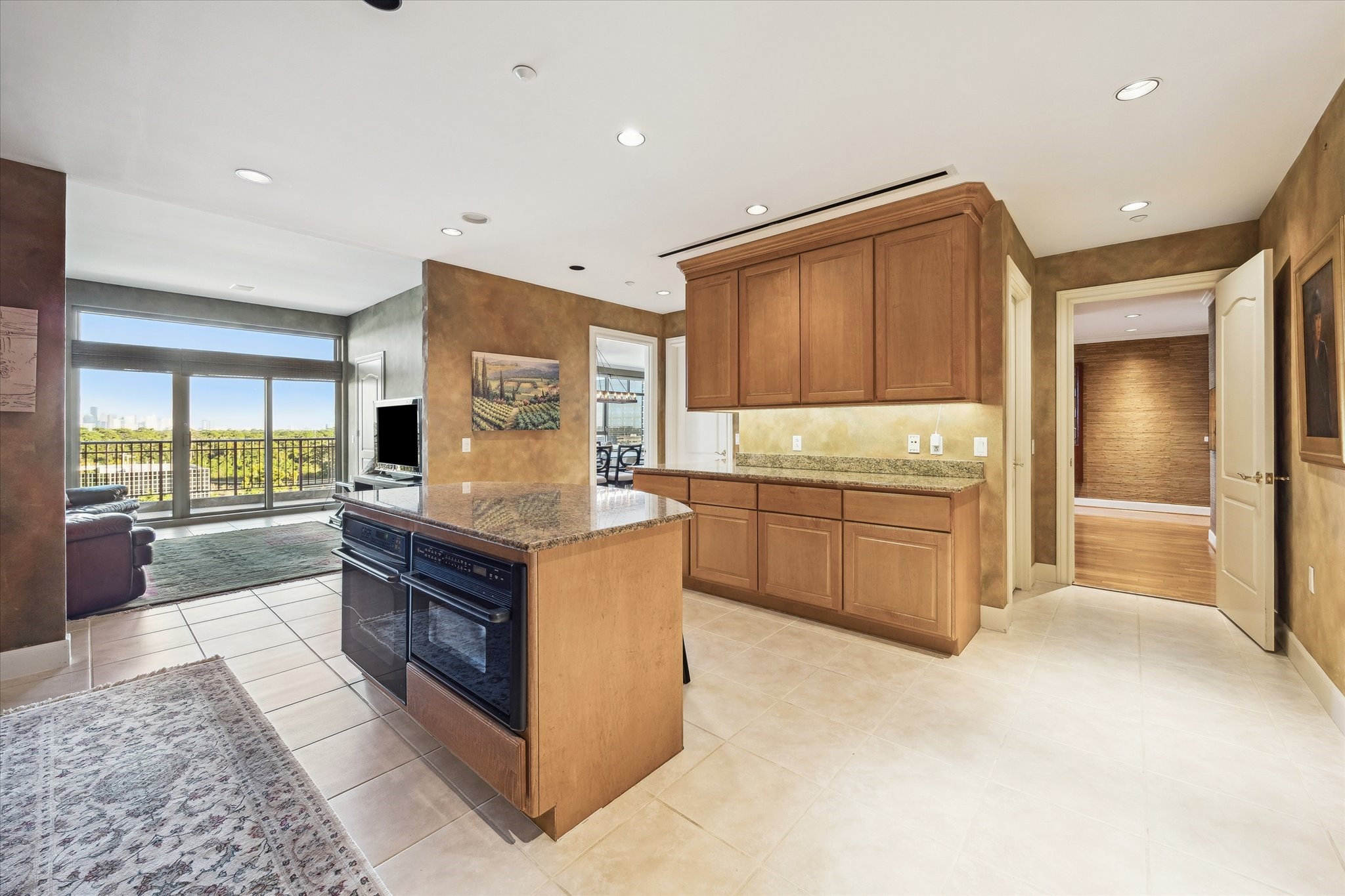 1000 Uptown Park Boulevard, Unit 93 Houston, TX 77056 - Photo 12 of 37 a large kitchen with stainless steel appliances granite countertop a stove and a refrigerator