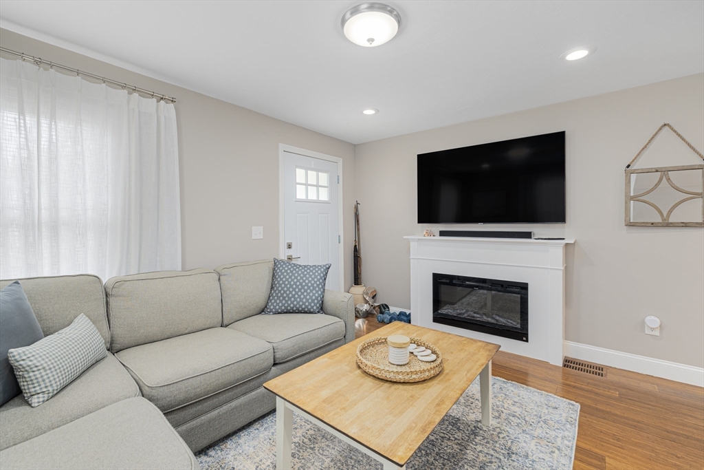 69 Denver Street Fall River, MA 02721 - Photo 19 of 35 a living room with furniture a fireplace and a flat screen tv