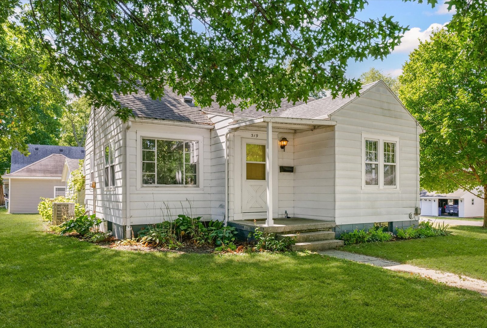 a front view of house with yard and green space