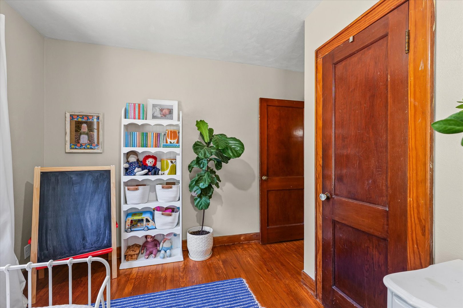 319 West Bond Street Monticello, IL 61856 - Photo 17 of 34 a room that has painting on the wall and a potted plant