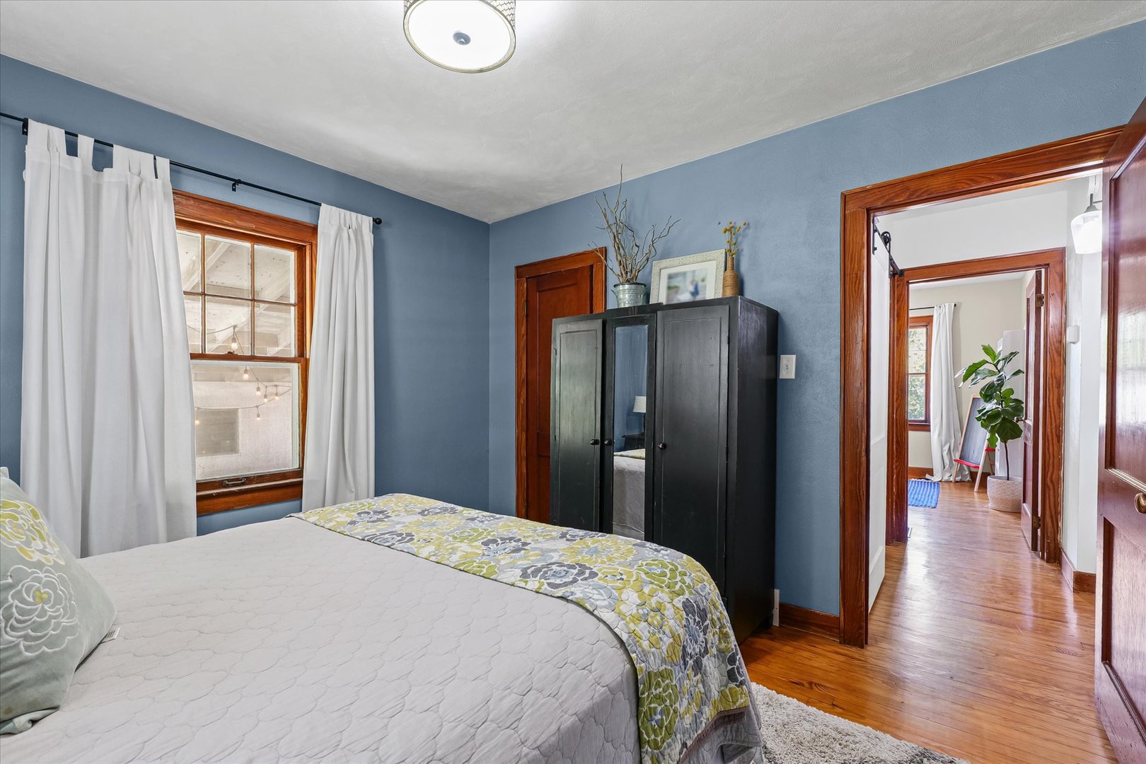 319 West Bond Street Monticello, IL 61856 - Photo 20 of 34 a bedroom with a bed and wooden floor