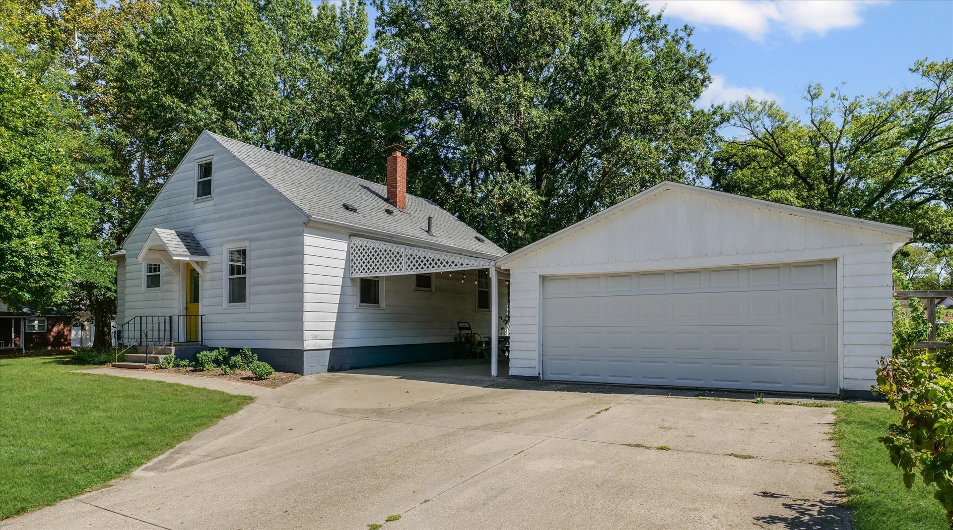 319 West Bond Street Monticello, IL 61856 - Photo 27 of 34 a front view of house with yard and trees in the background