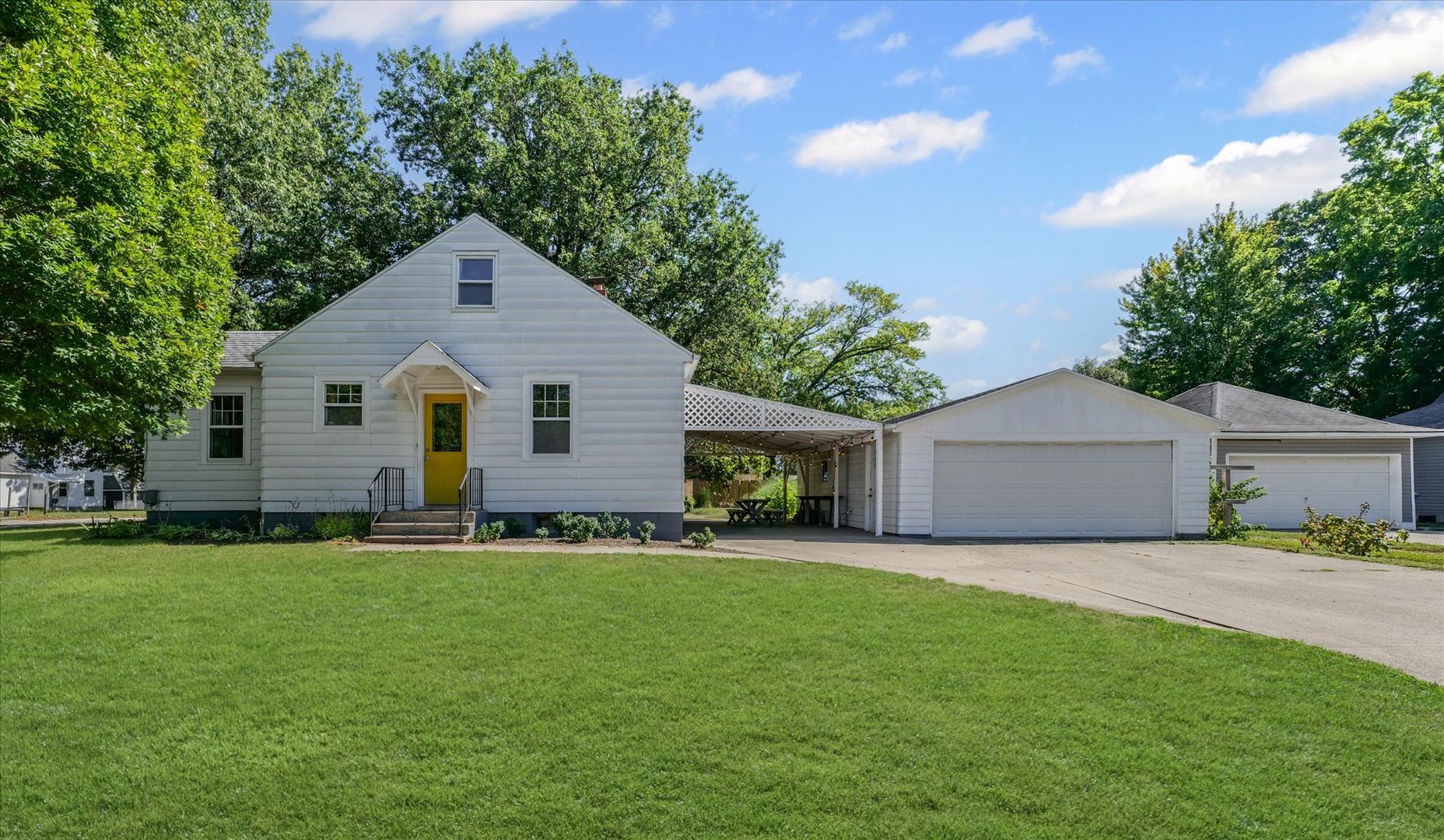 319 West Bond Street Monticello, IL 61856 - Photo 33 of 34 a front view of house with yard and trees in the background