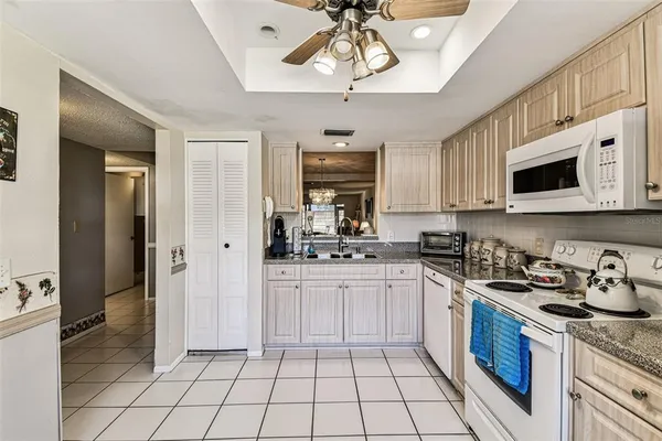 a kitchen with granite countertop cabinets stainless steel appliances and a counter space