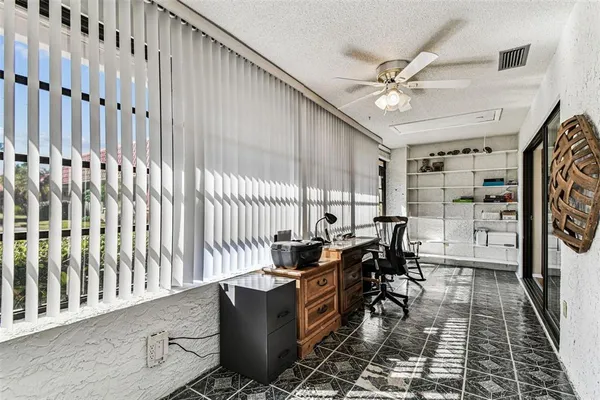 a bedroom with a bed wooden floor and window