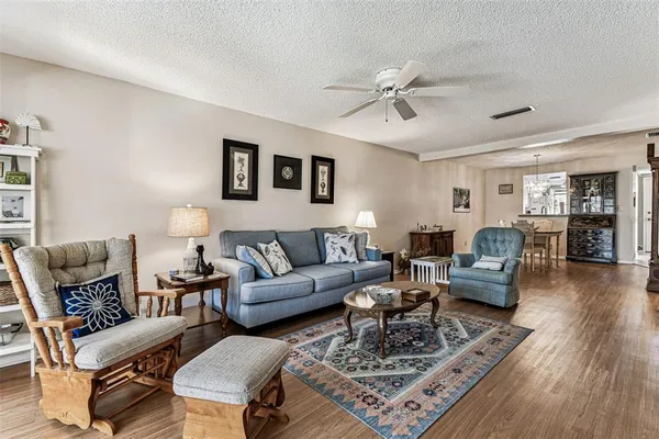 a living room with furniture and wooden floor