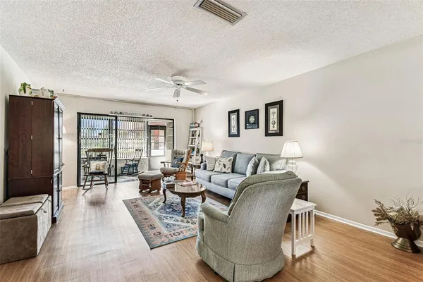 a living room with furniture window and wooden floor