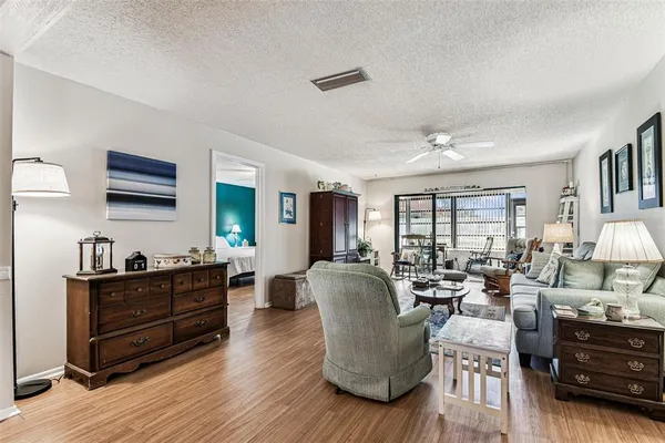 a view of a dining room with furniture wooden floor and chandelier