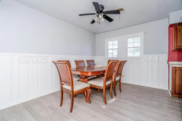 a dining room with furniture window and wooden floor