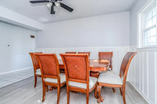 a dining room with furniture and window