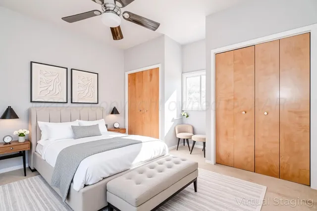 a bedroom with a bed couches and wooden floor