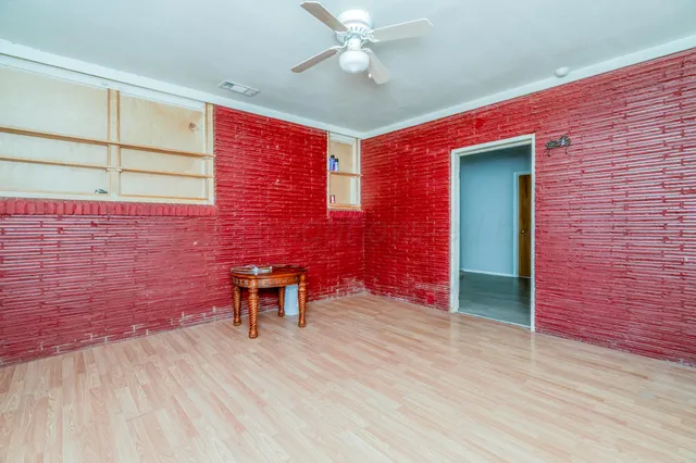 a front view of house with yard and trees in the background