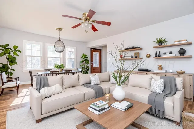 a living room with furniture kitchen and a chandelier