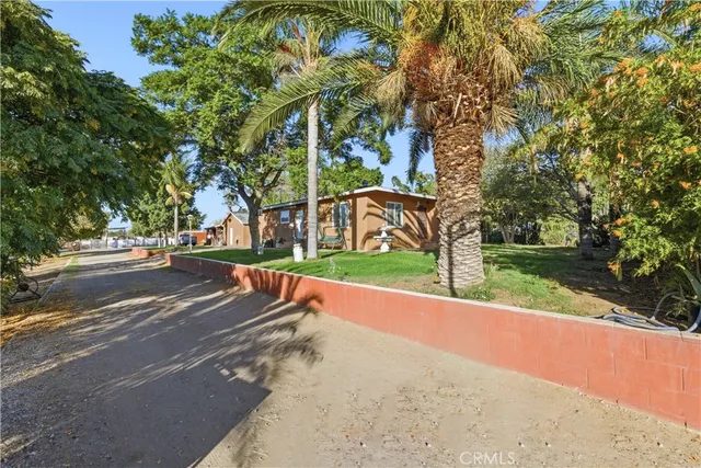 a kitchen with stainless steel appliances granite countertop a stove a sink dishwasher and cabinets with wooden floor