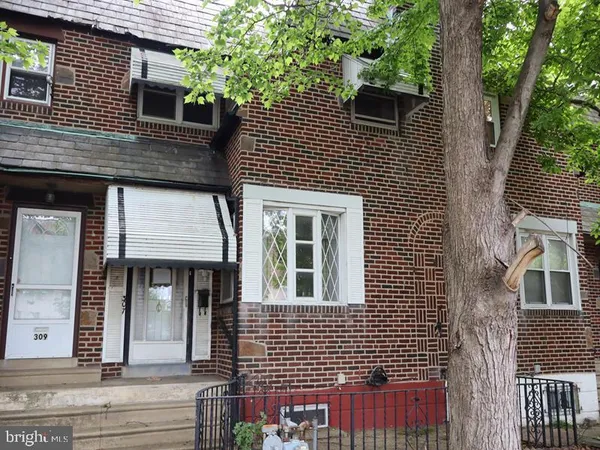 a view of a brick house with large windows