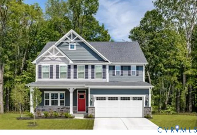 a front view of a house with a yard and trees