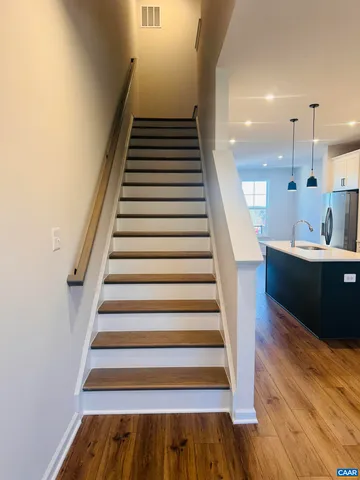 a view of entryway and hall with wooden floor