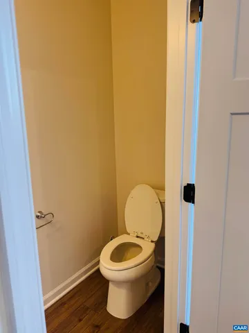 a white toilet sitting next to a small bathroom