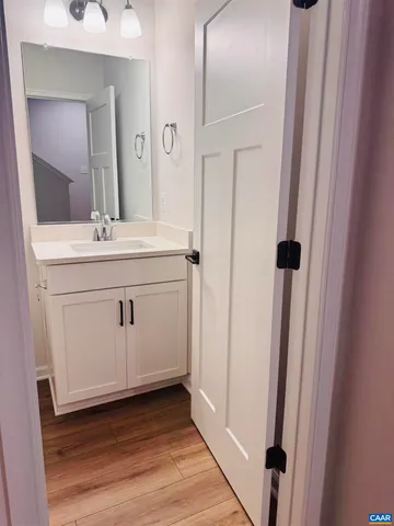 a view of a hallway with wooden floor and entryway