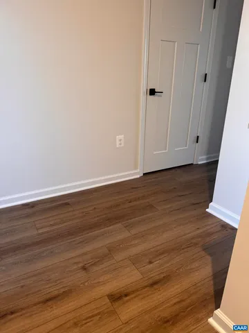 a view of closet with wooden floor