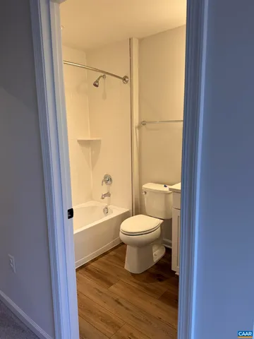 a white toilet and tub sitting next to a bathroom sink