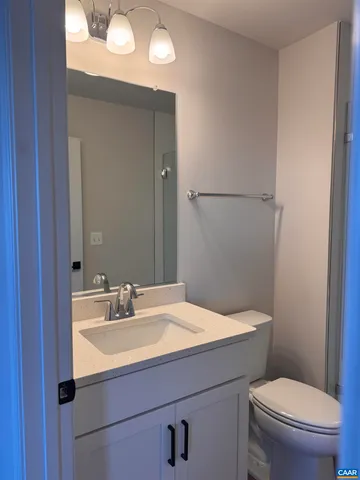 a bathroom with a sink and a glass door shower