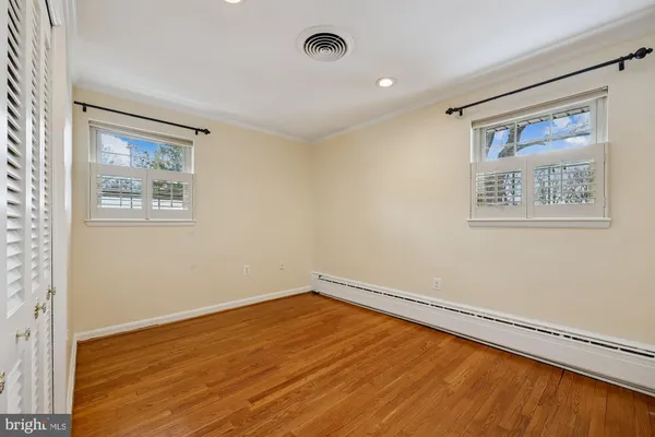 a view of a room with wooden floor and window