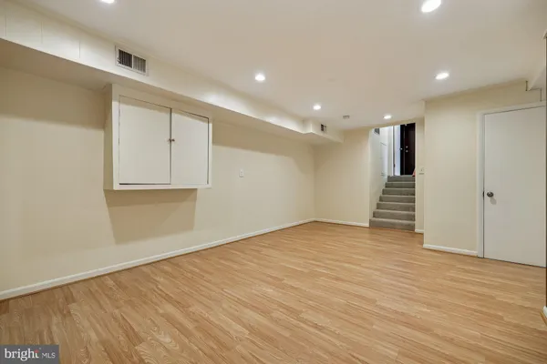 a view of an empty room with wooden floor
