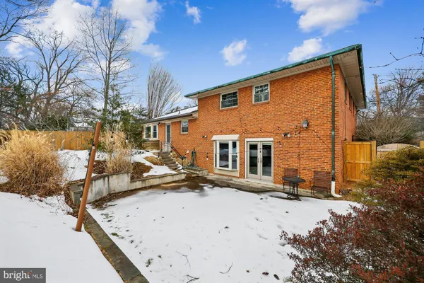 a view of a house with snow on the road