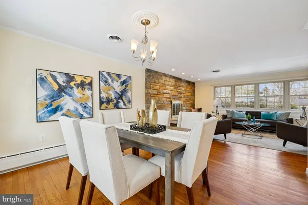 a dining room with furniture a window and wooden floor