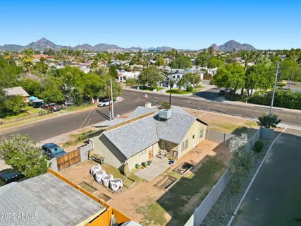 an aerial view of a house with a yard