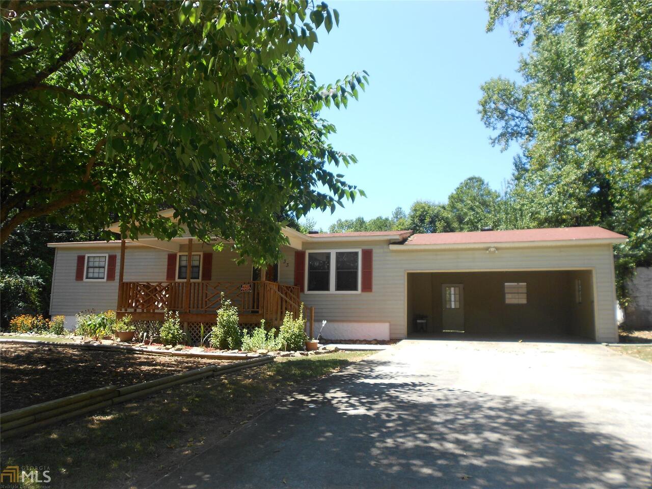 a front view of a house with yard and trees