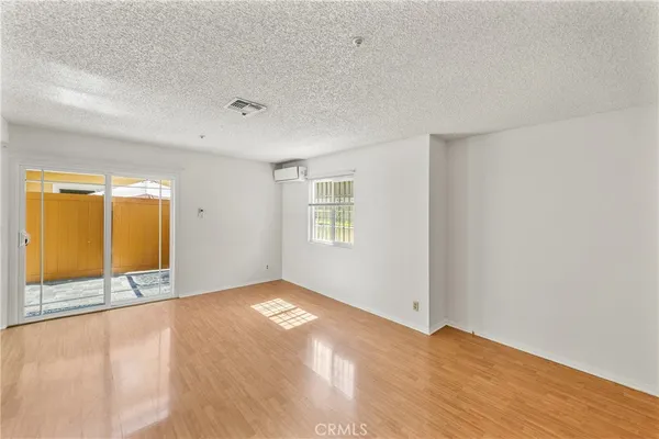 a view of an empty room with glass door