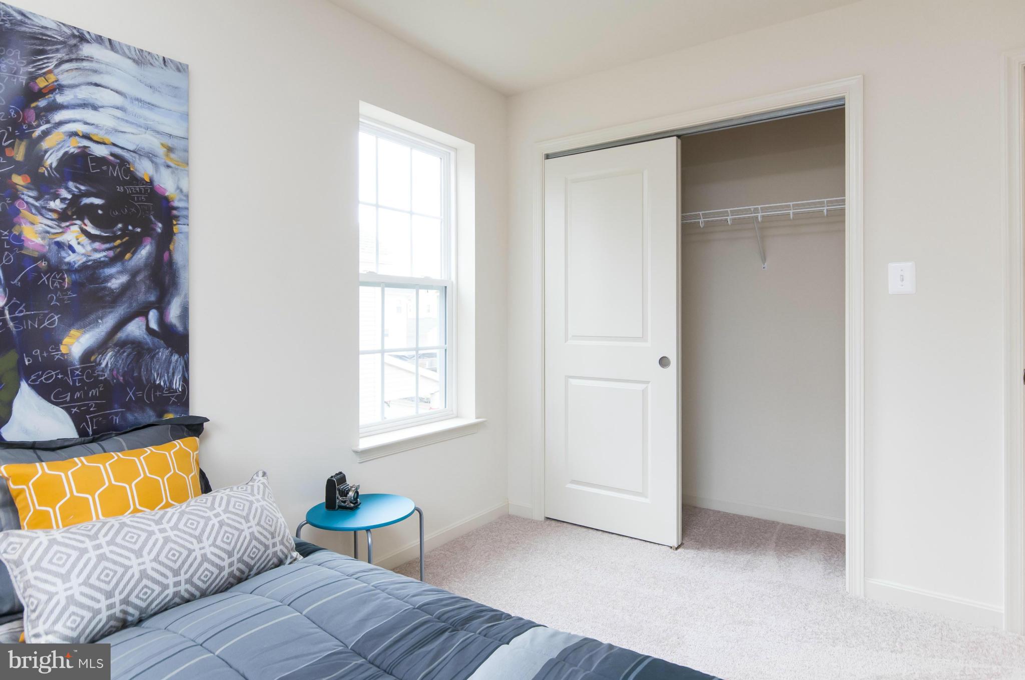 1622 Renaissance Drive Baltimore, MD 21221 - Photo 13 of 20 a view of a bedroom with a bed and a window