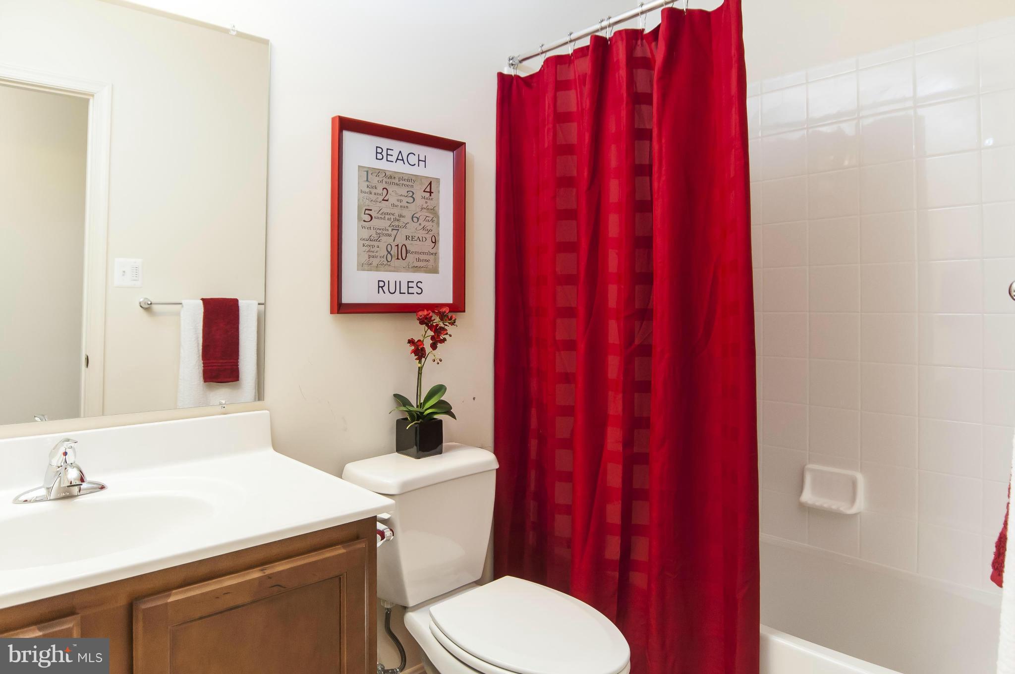 1622 Renaissance Drive Baltimore, MD 21221 - Photo 15 of 20 a bathroom with a sink a toilet a mirror and vanity