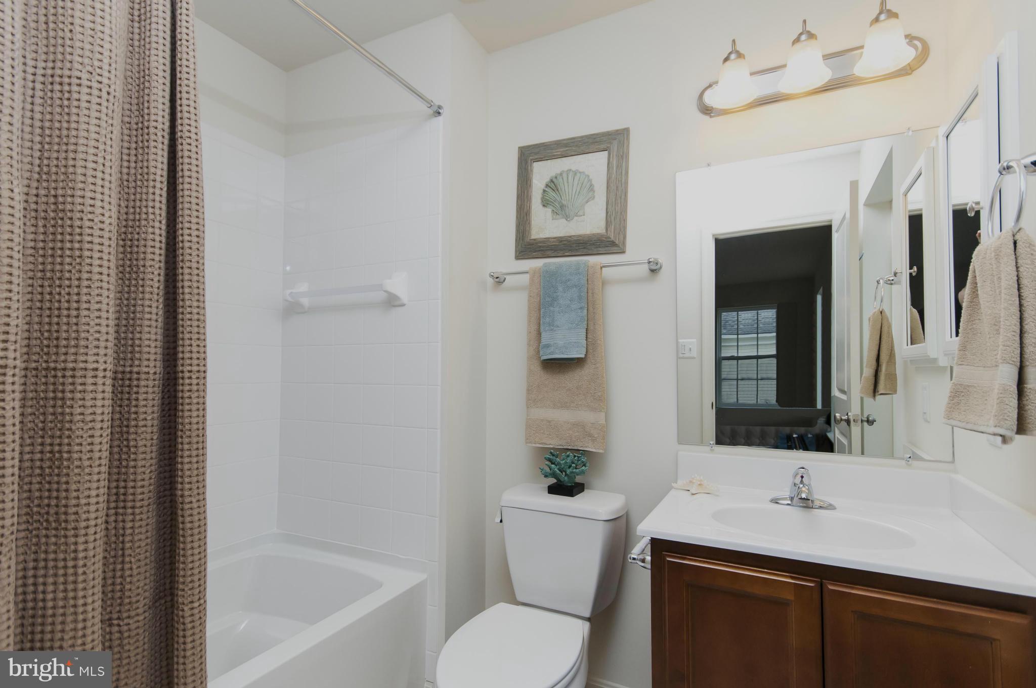 1622 Renaissance Drive Baltimore, MD 21221 - Photo 18 of 20 a bathroom with a granite countertop sink toilet and shower